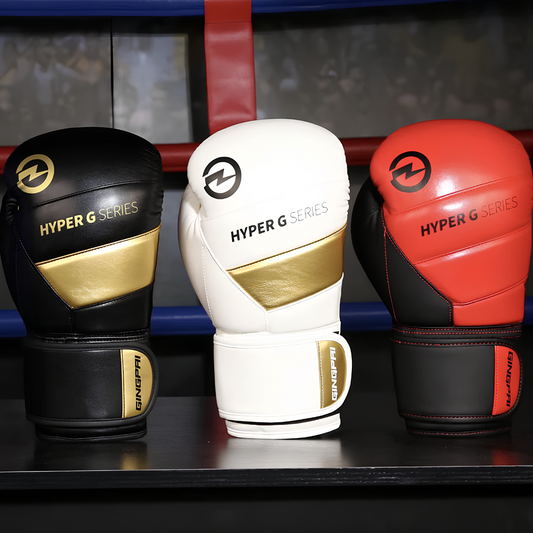 A collection of Hyper G Series boxing gloves in black, white, and red with golden accents, ideal for beginners and professionals.