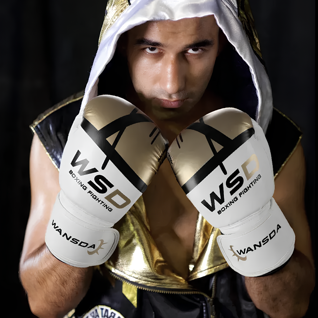 An athlete in premium boxing gloves with a black and gold design, ready for competition.